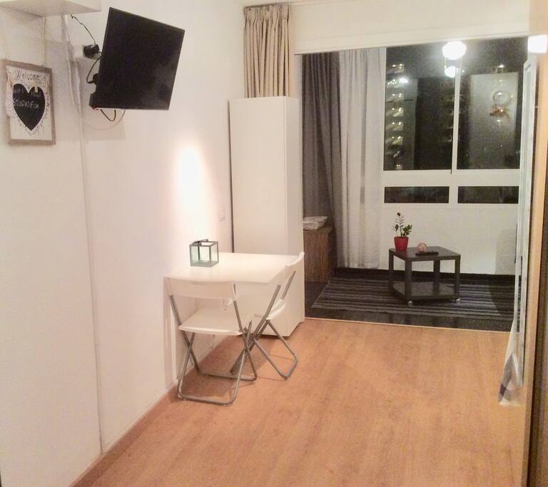 TV on swivel arm can be viewed from bed or the sofa.