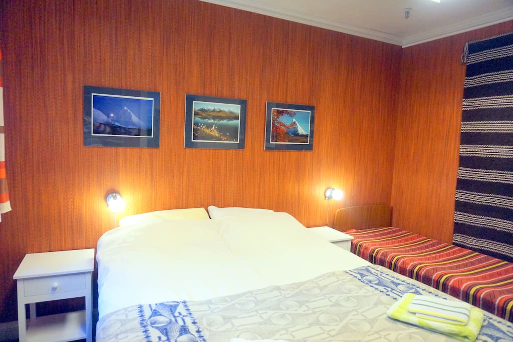 The room with a double bed and a single bed.