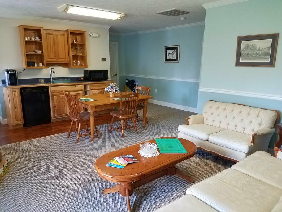 Living room/kitchenette with microwave, coffee maker, refrigerator & sink