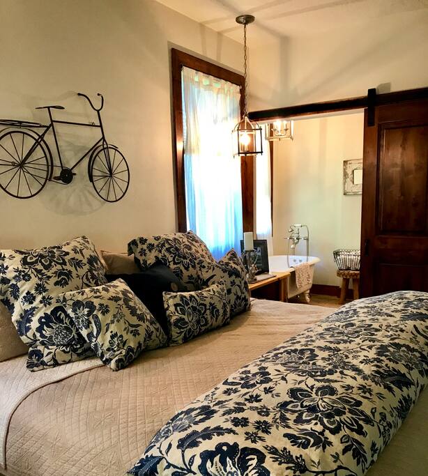 Master Bedroom with King bed and full size bathroom with soaking tub, walk in shower, vanity and view.
