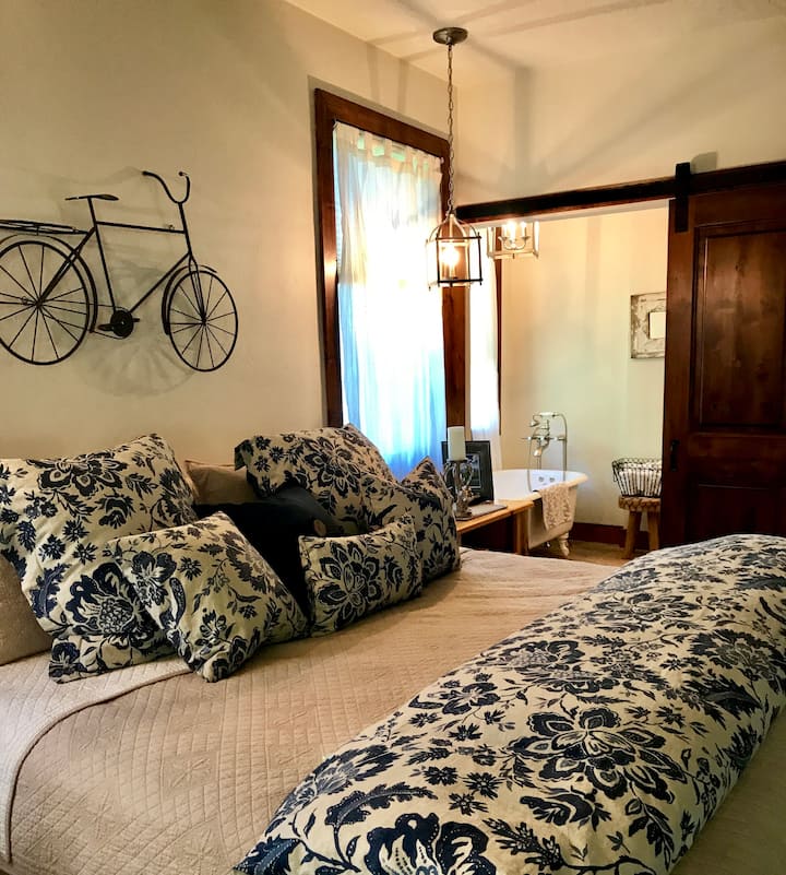 Master Bedroom with King bed and full size bathroom with soaking tub, walk in shower, vanity and view.