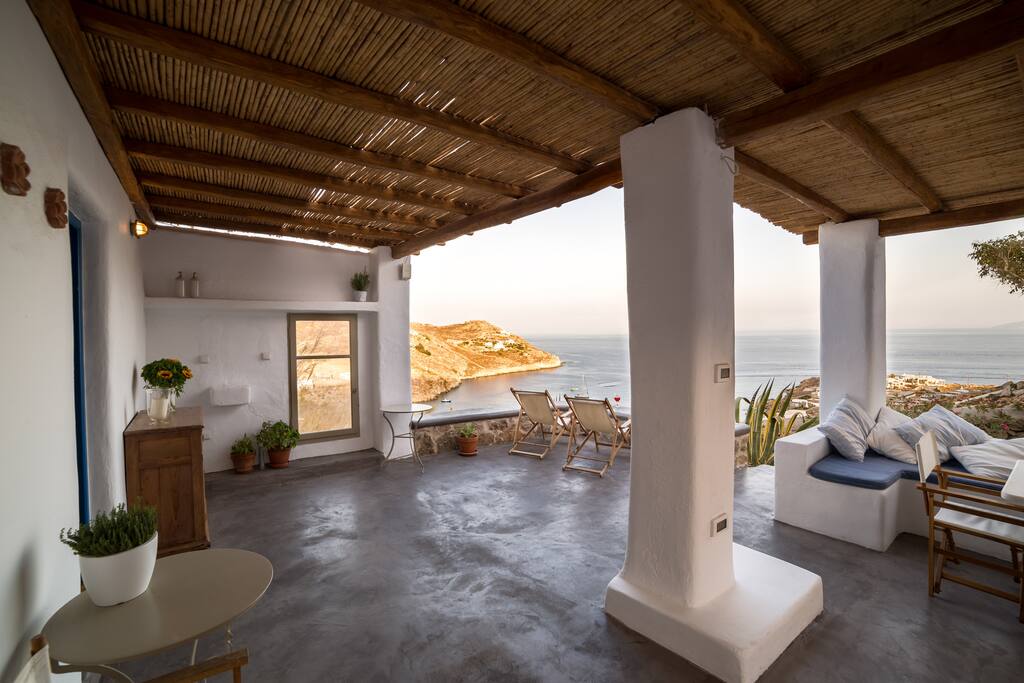 Wisely positioned to protect its guests from the frequent Mykonean north winds, the veranda is pleasing and relaxing.
The shaded but breathing top ensures protection from the stunning day light (neighbor island Delos is considered the brightest place on earth) while allows breezes of fresh air to go through and pleasantly cool you down.