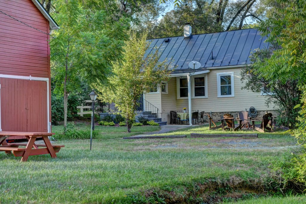 The backyard is perfect for grilling, enjoying the fire pit, or having a meal at the picnic table