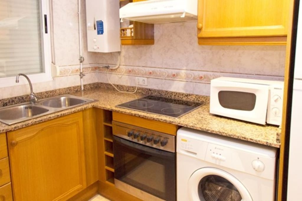 The fully functional kitchen features appliances, utensils, crockery, cutlery and a washer for added convenience