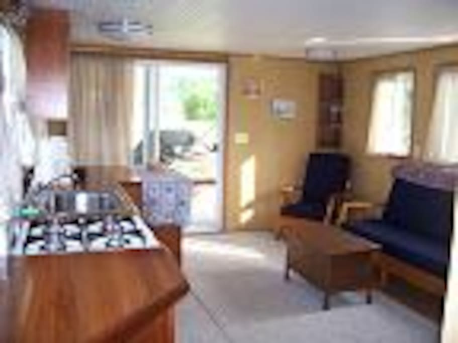 Main Salon is equipped with a couch and two chairs. A TV with DVD and VHS capabilities with a large selection of movies.