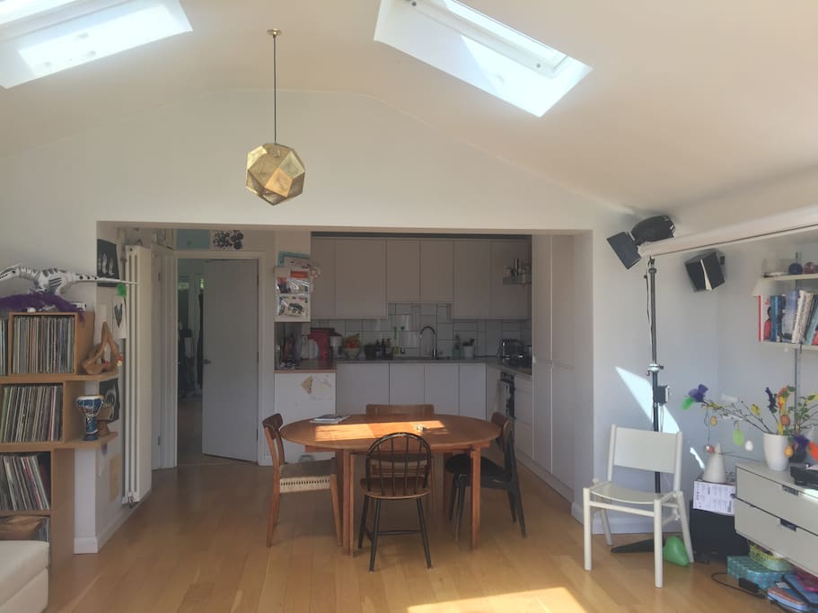 Looking back from the open plan living area to the modern and well equipped kitchen. The utility room is to the side of the kitchen (with washer & drier).