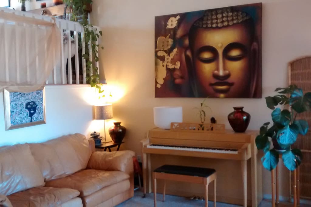 Bright, warm welcoming entry level living room-the Golden Buddha Room. Yes, please play the piano!