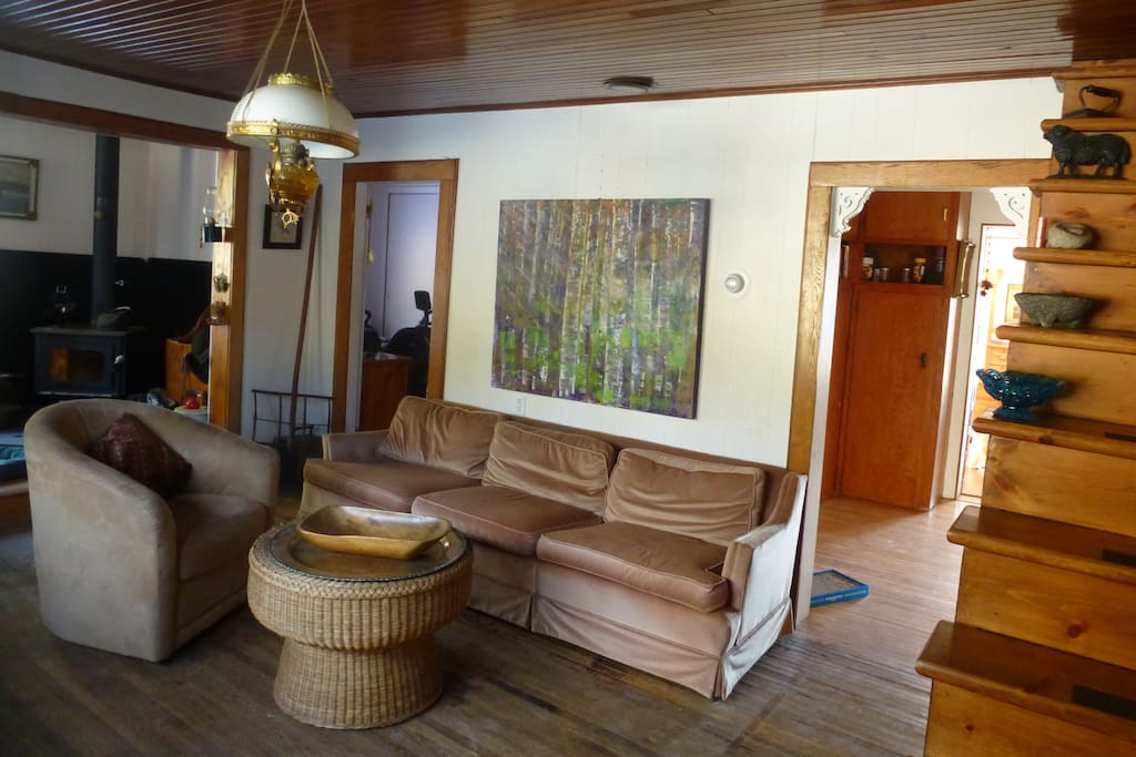 100 year old living room with hardwood floors/ceiling and wood stove in the corner for chilly nights...