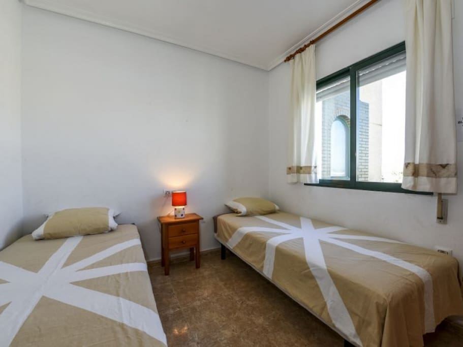 Second bedroom with 2 single beds and built in wardrobe