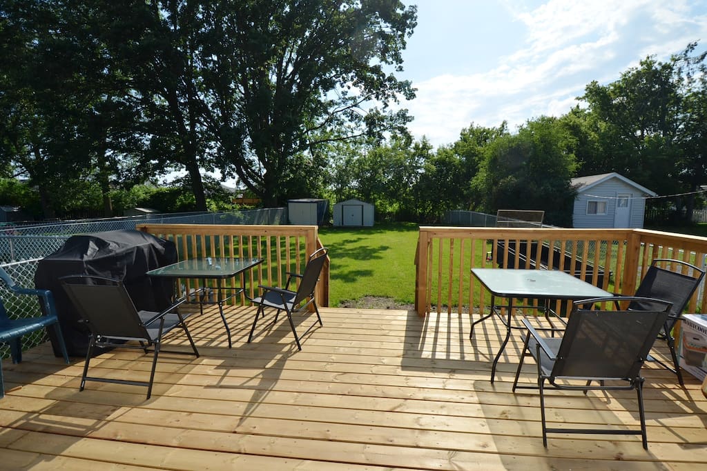 back deck with BBQ and patio furniture, note the fenced dog run on the left