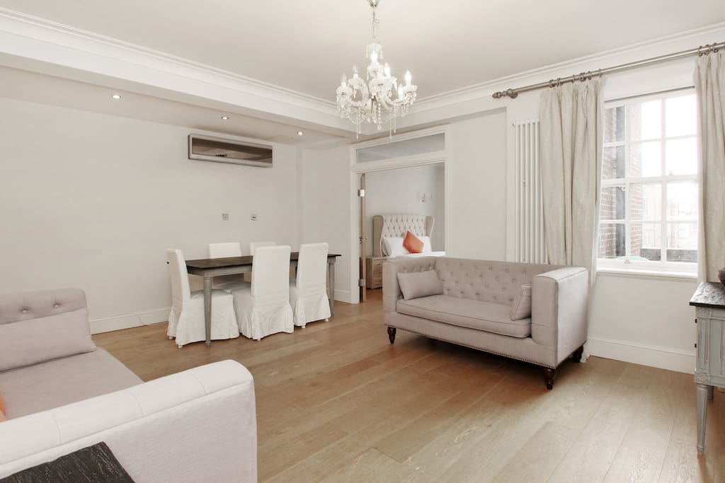 The exceptionally spacious Lounge with sofas, dining table and chairs and TV with satellite channels