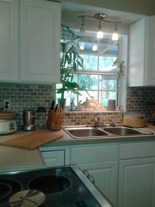 Bright and sunny kitchen overlooking back deck and yard.