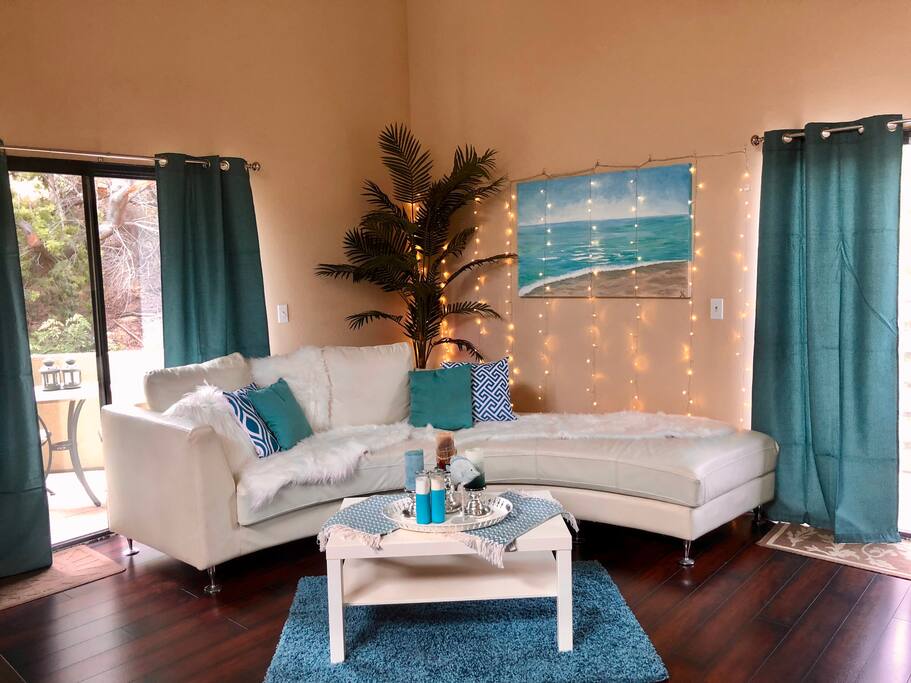 We updated the brown sofa sectional for a fresh white semi circle sofa and an aqua colored beach theme in living room. 2 foldable memory foam mattresses are available for extra guests to sleep (2 in queen bed, 2 on memory foam = 4 guests total) .