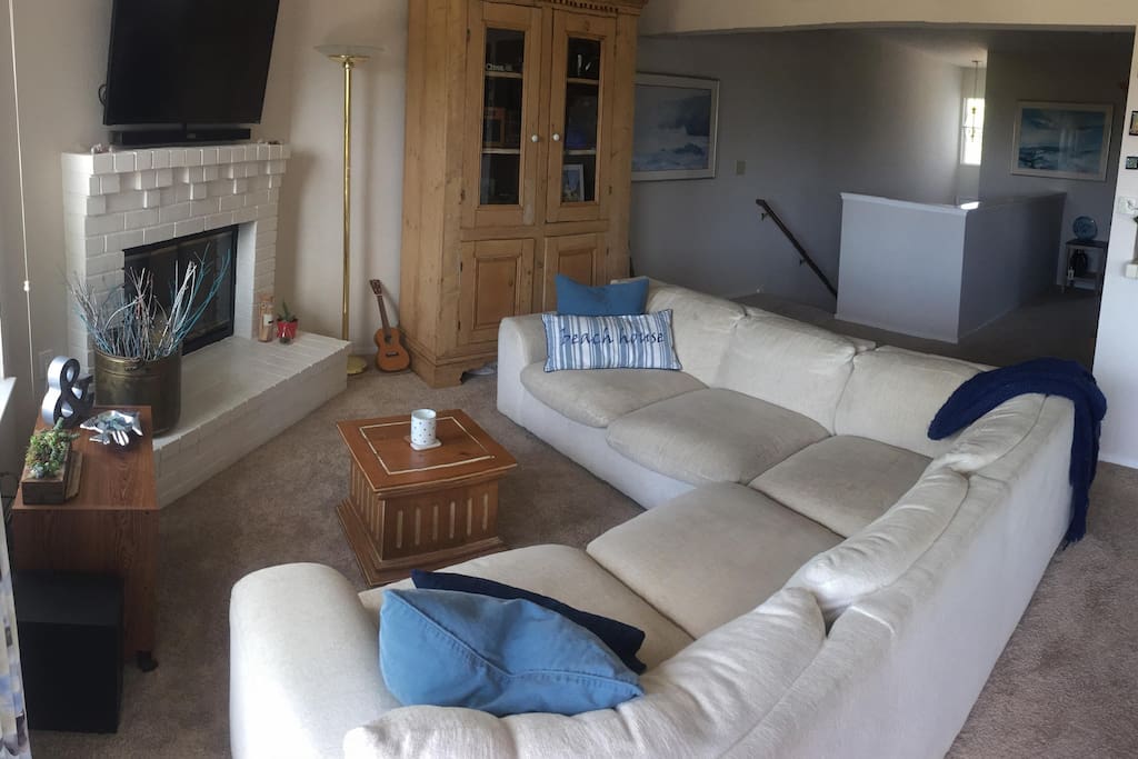 Here is another picture of our living room. Our guest rooms are down the staircase, when you come up you will see this and the kitchen on your left.