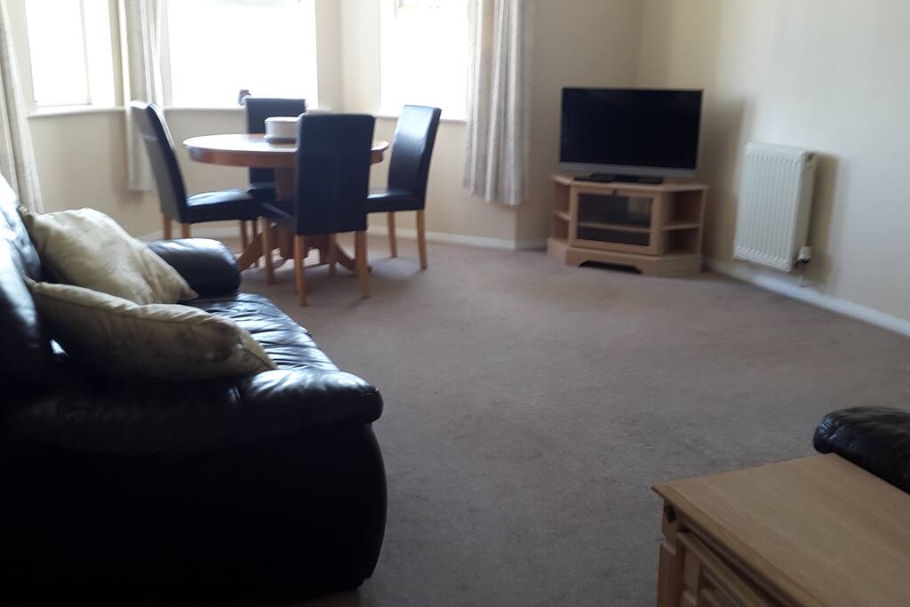 Spacious living room with simple but tasteful furnishings