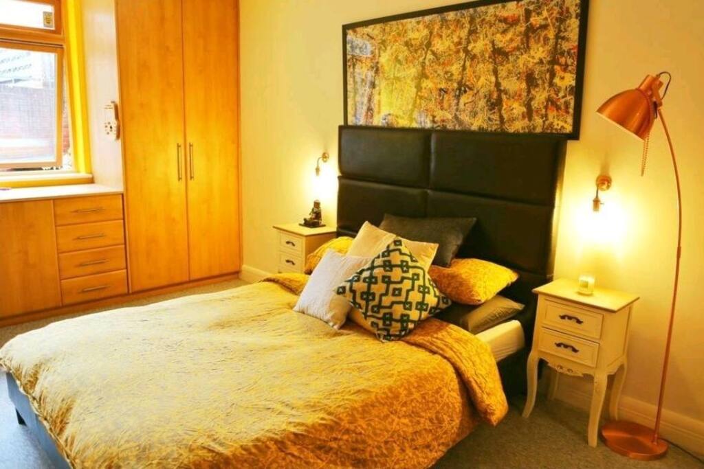 Master king bedroom with natural light and view of quiet patio