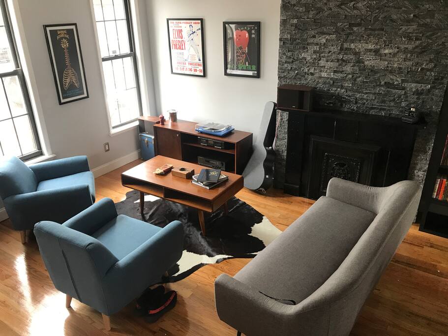 Living room has plenty of seating as well as a stereo equipped with a turntable and cassette deck as well as plent of music to choose from.