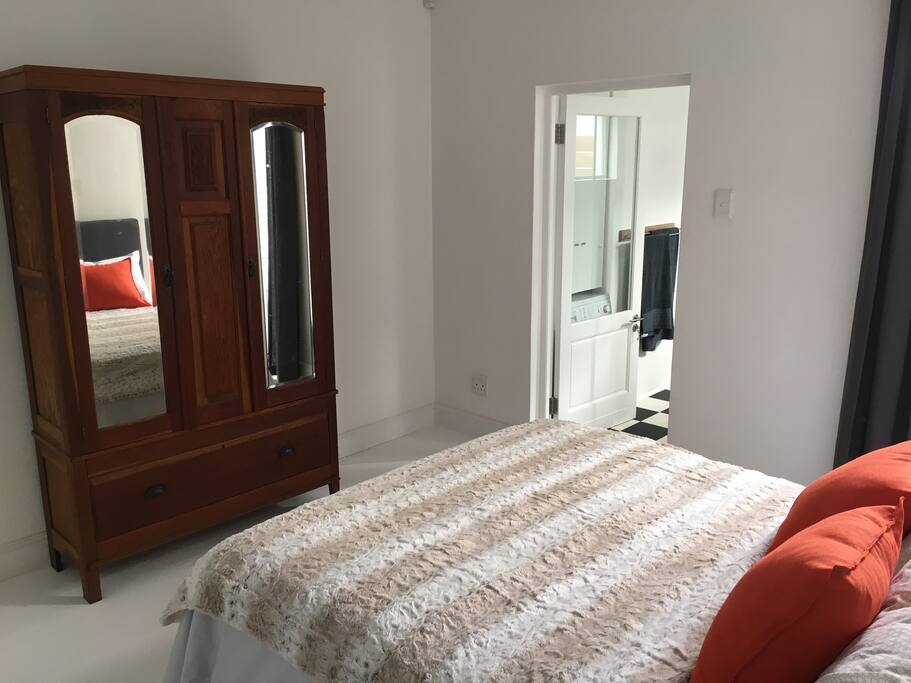 Top-of-the range Queen size bed and antique wardrobe