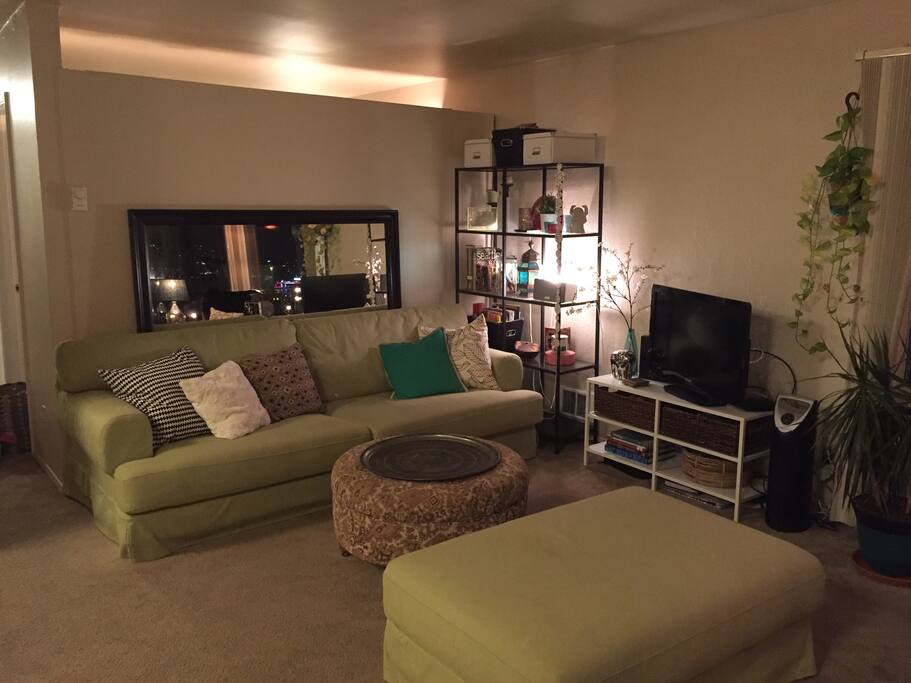 Comfortable couch with flexible layout options. Great for sleeping as is, or move the ottoman to make an L-shape if you want more room. Rolling circular ottoman with hard surface metal tray on top. Also great for serving outside. TV has basic cable input as well as DisplayPort>HDMI connection for laptop streaming.