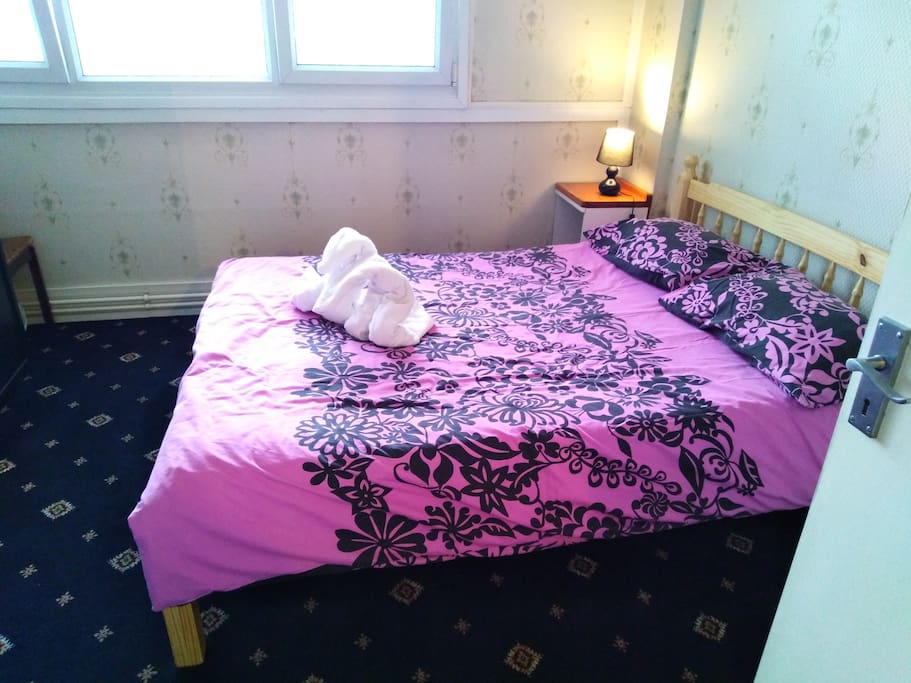 Lovely large clean well-lit bedroom with luxurious carpet.