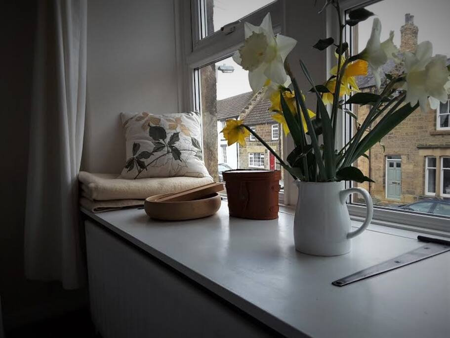 The window seat faces east and catches the morning sun
