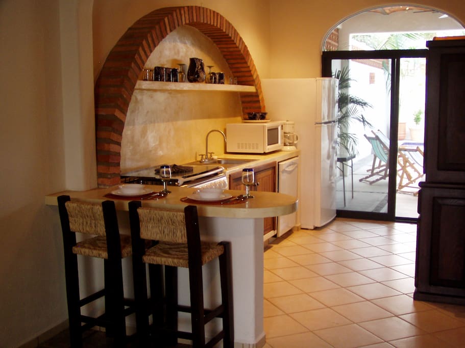 Kitchen and breakfast bar - opens to terrace dining area, fountain & pool