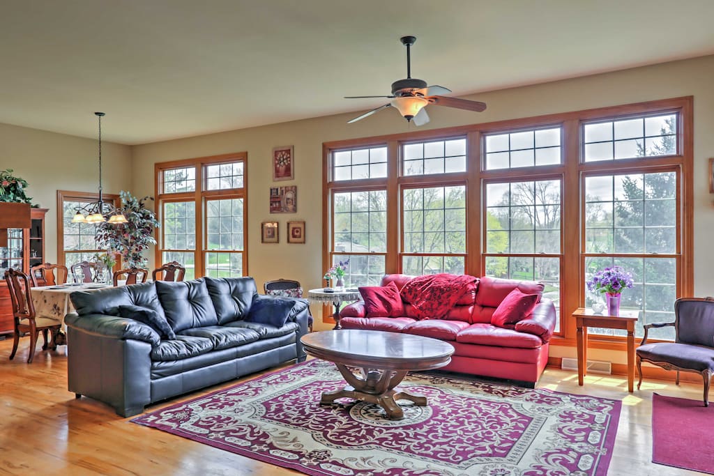 Enter the first floor of the home, where hardwood floors greet your feet and floor-to-ceiling windows provide beautiful views that illuminate the interior with natural sunlight.