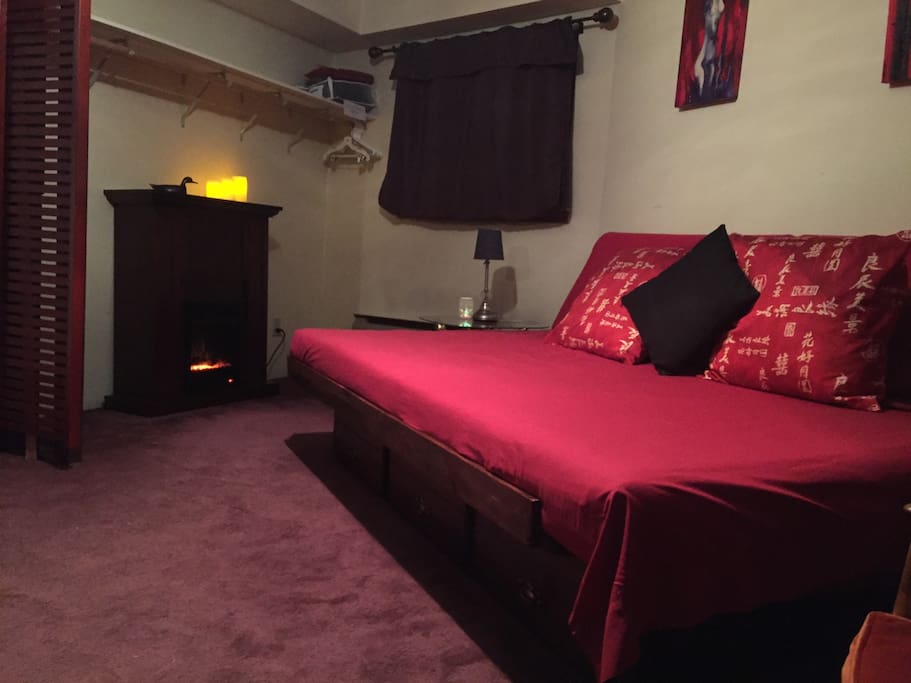TV room with fireplace. A great place for cold winter nights. Nice and cool for hot summer days.
Couch is also queen size bed. Access to bathroom is through this second "bedroom".
