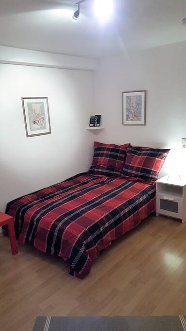 Comfy bed with freshly laundered bedding.