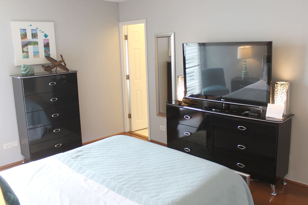 Large TV in master bedroom equipped with cable.