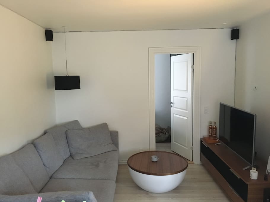 Living room with TV and sound system.