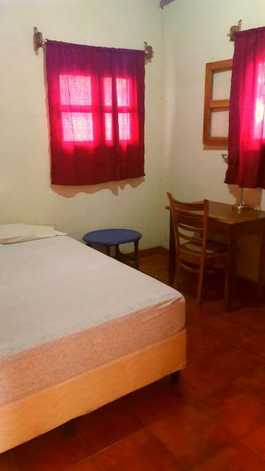 Small room with queen size bed and desk