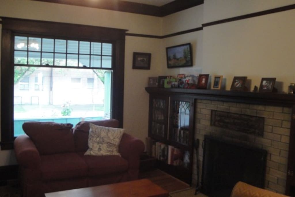 Living room with wood burning fireplace.