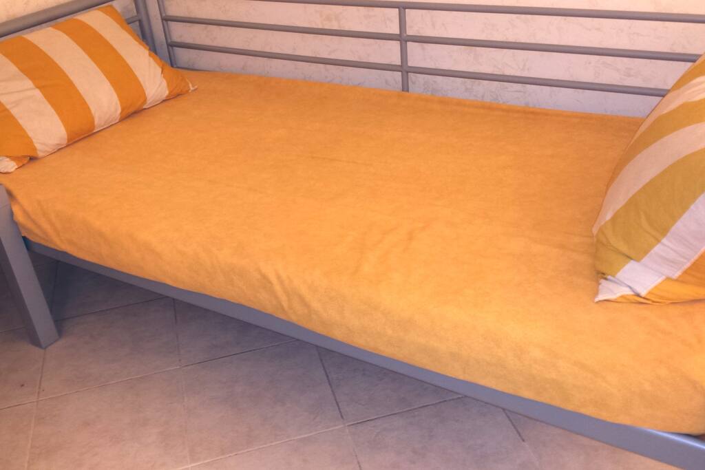 the master single bedroom with a thin mattress and slatted