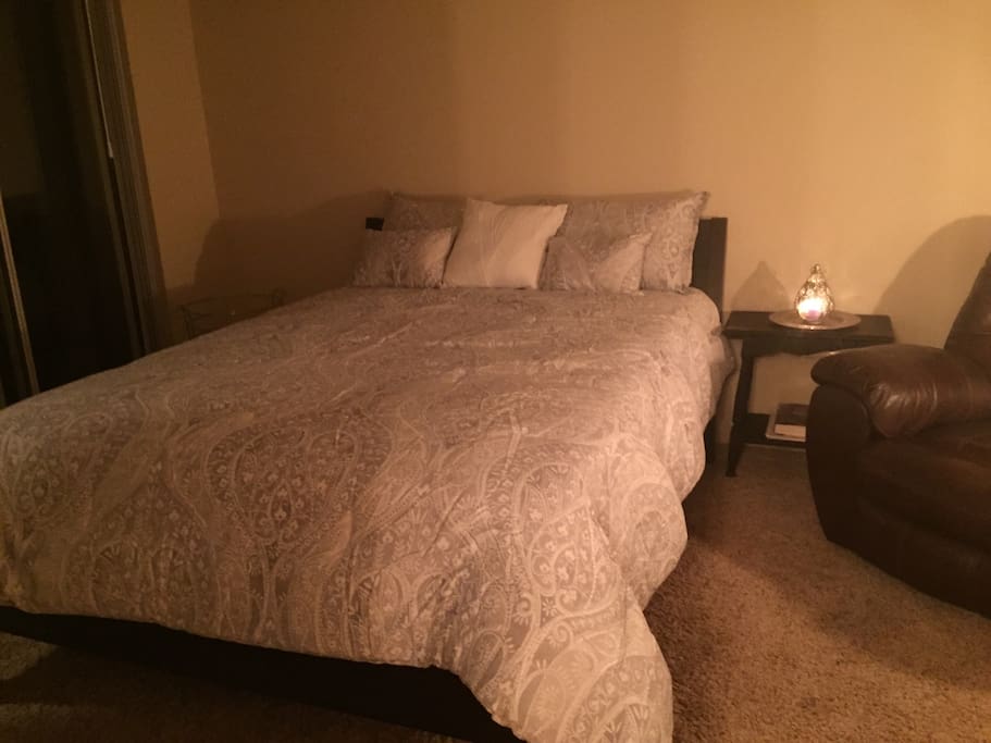 Brand New Queen size Bed complete with new bedding, Cool gel memory foam mattress, reclining chair, and night stand.