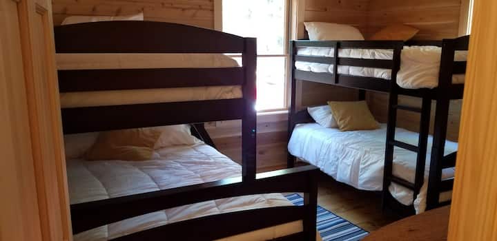 Twin over full and twin bunk beds in large bedroom
