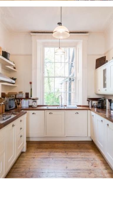 Here's a photo of the kitchen from the property sales brochure when we bought it last year. It hasn't changed at all. We've got a hob, two ovens, dishwasher, normal appliances like kettle coffee machine etc