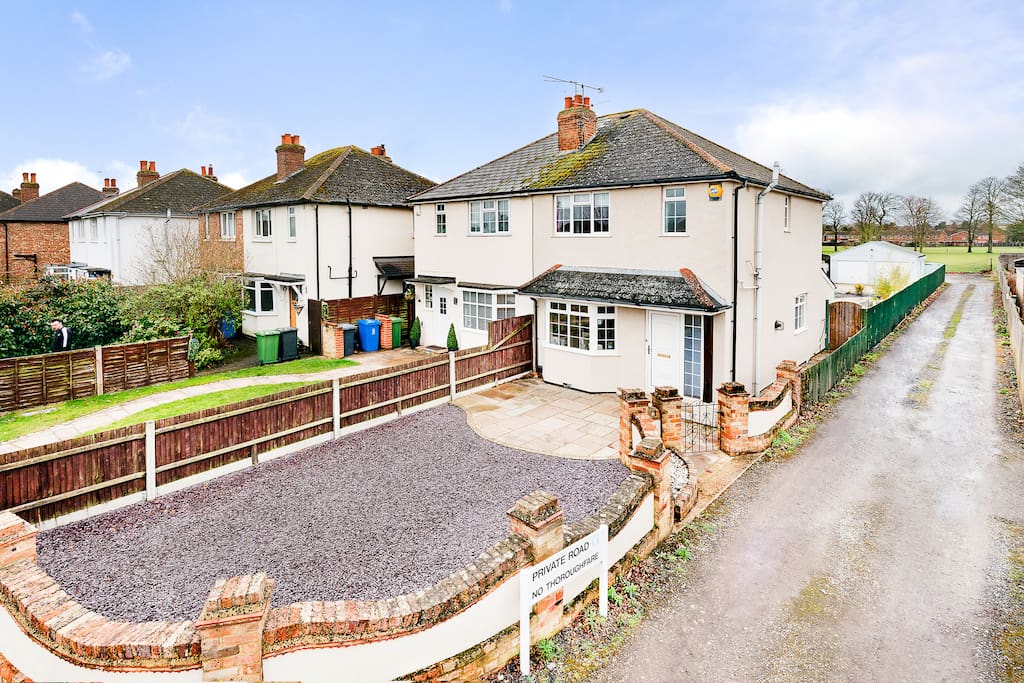 Private front entrance from private road, leading to off road parking and park land.