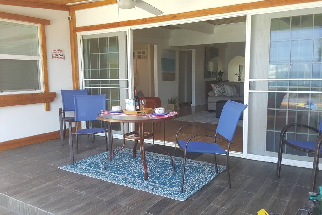 Another table and chair set up joining the living room and pool area