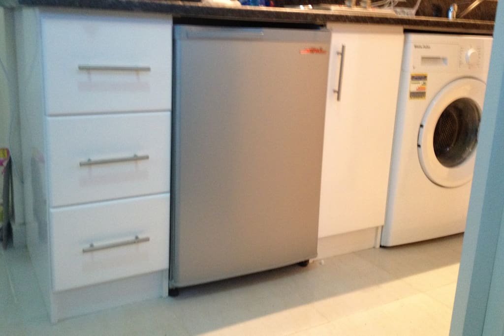 Nicely appointed kitchen with clothes washer.