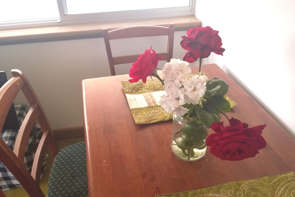 Garden space has many rose bushes. Help yourself when they are in bloom