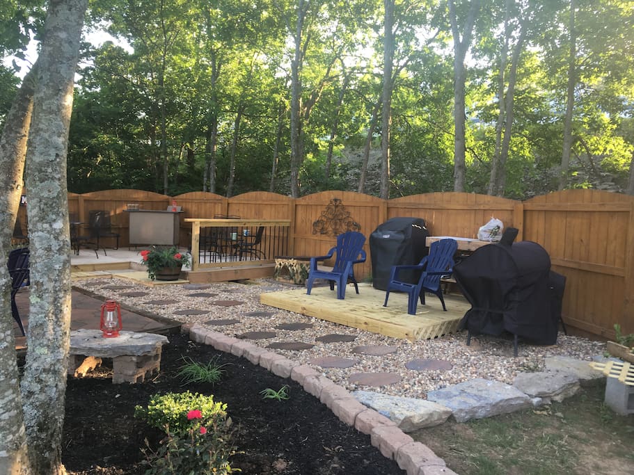 one of three entertainment areas in a fenced private yard.