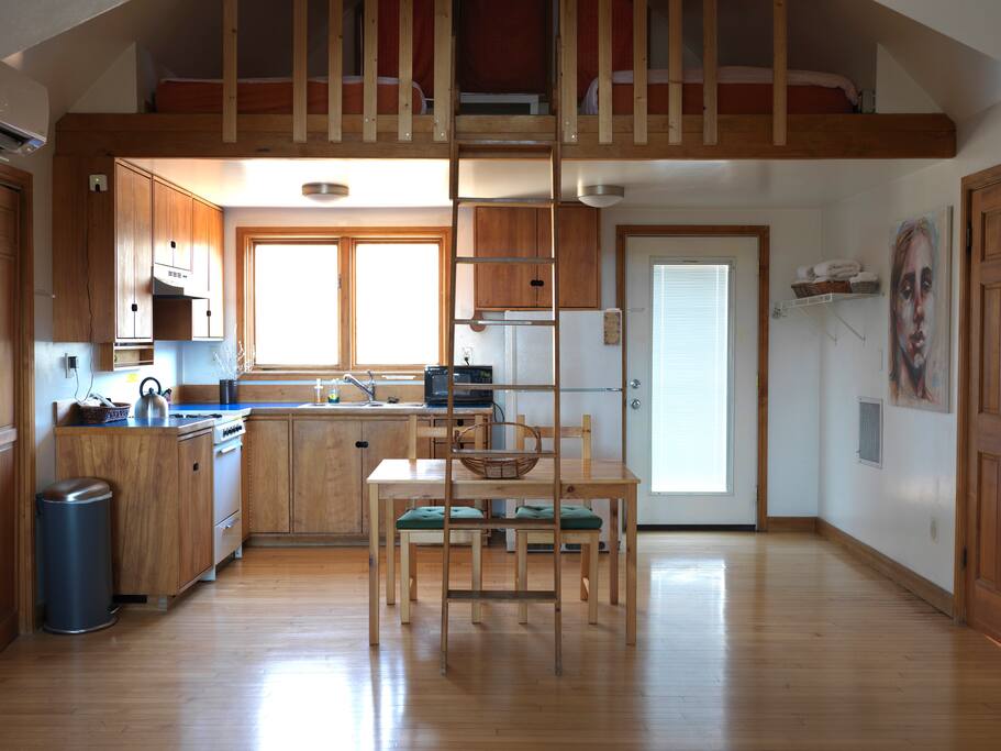 Two full size beds above the kitchen