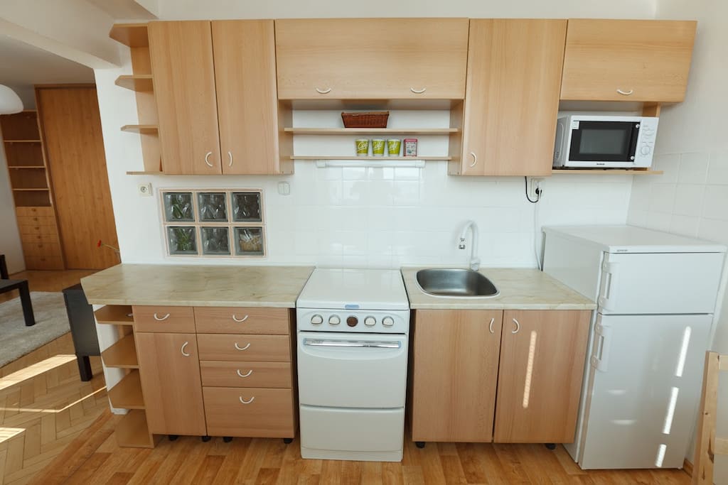Kitchen with cooker, fridge, microwave and kettle