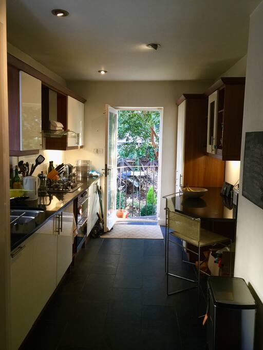 Kitchen (shared), with view on to back garden