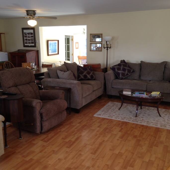 Living room with view of sun room in back