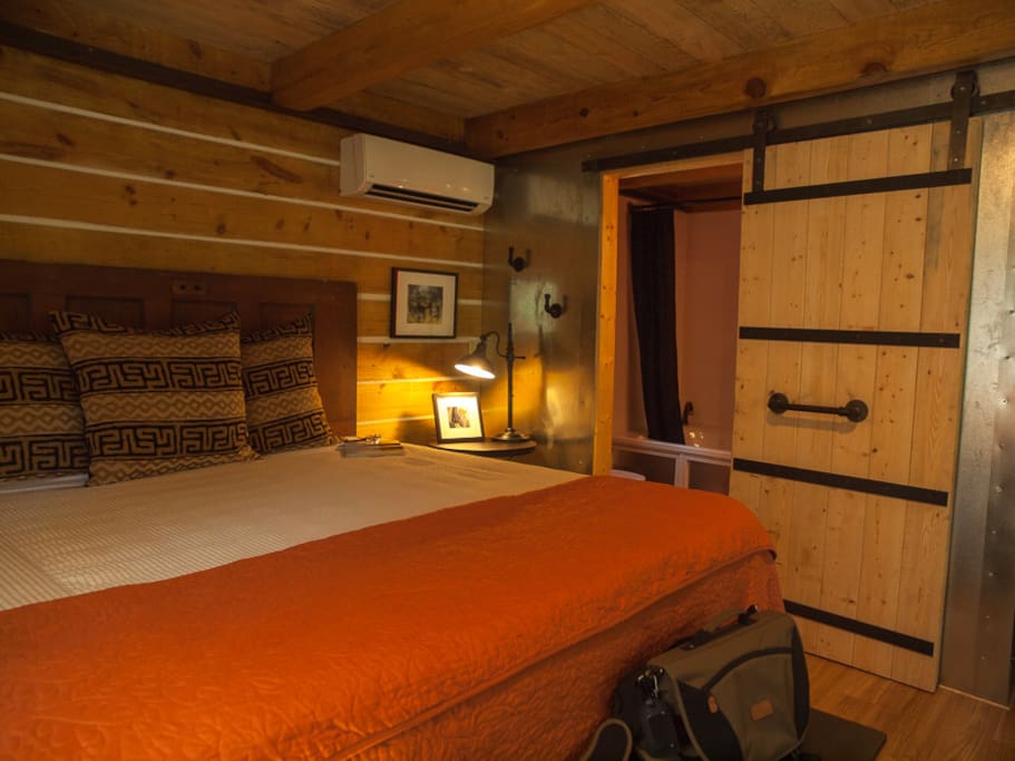 King bed, rustic barn door to jetted tub bathroom