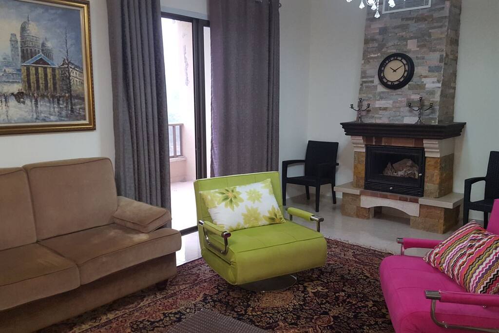 The living room with a nice Fireplace as well with a nice balcony to have a nice view to the mountains and the City
