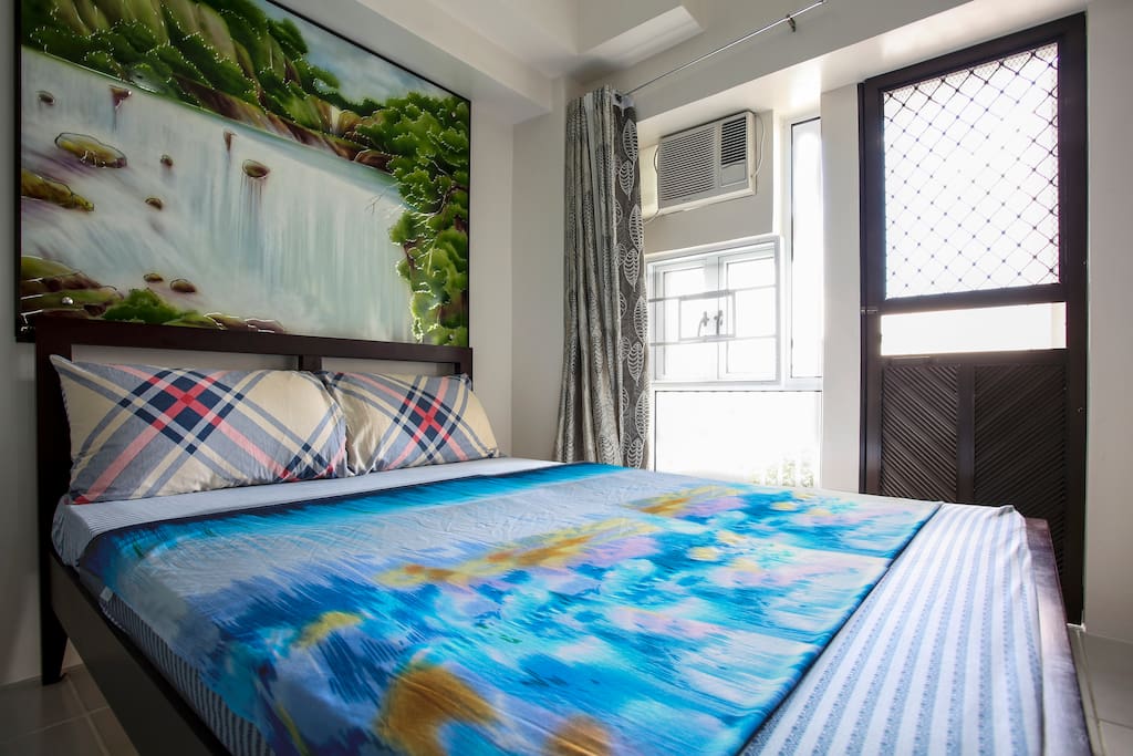 Bedroom with Air conditioner. Window & door have screens so you can just let the window and door open to feel the fresh air coming from the virgin forest in front of the location of Condominium.