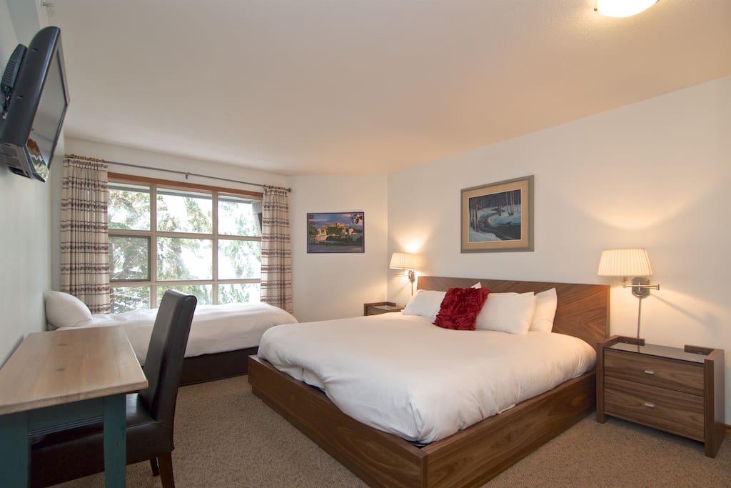 The master bedroom with a king size bed and a single bed.